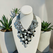 Load image into Gallery viewer, Elegant beaded necklace on a mannequin bust with plants in the background