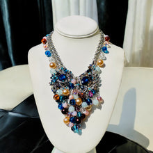 Load image into Gallery viewer, #BeadedBibNecklace
#MulticoloredJewelry
#BlueAndPinkNecklace
#StatementNecklace
#HandcraftedNecklace
#ColorfulJewelry
#BohoChicNecklace
#HandmadeJewelry
#VibrantAccessories
#BoldNecklace
#UniqueNecklace
#ElegantJewelry
#SpecialOccasionJewelry
#FashionNecklace