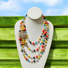 Load image into Gallery viewer, - #StatementNecklace  
- #BeadedJewelry  
- #YellowFlowerNecklace  
- #MultiStrandNecklace  
- #BohoJewelry  
- #HandcraftedJewelry  
- #ColorfulAccessories  
- #BoldNecklace  
- #SummerJewelry  
- #FestivalStyle  
- #UniqueNecklace  
- #ArtisanJewelry  
- #FloralNecklace