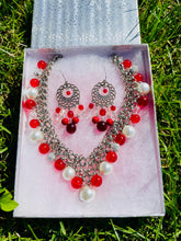 Load image into Gallery viewer, Jewelry set with necklace and earrings on a white box against a grass background
* Red and White Jewelry
* Multi-Colored Beaded Set
* Beaded Necklace and Earrings
* Handmade Jewelry
* Colorful Jewelry
* Boho Jewelry
* Gift for Her
* Holiday Jewelry
* Statement Accessories
* Fashion Jewelry
* Casual Jewelry Set
* Women's Necklace Set
* Red Jewelry
* Matching Jewelry Set
* Handmade Necklace
* Beaded Earrings
* Unique Jewelry
* Festive Jewelry
* Vibrant Jewelry
* Summer Accessories